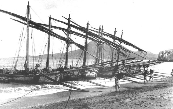 old boats and miners on the beach of southern Sardinia
